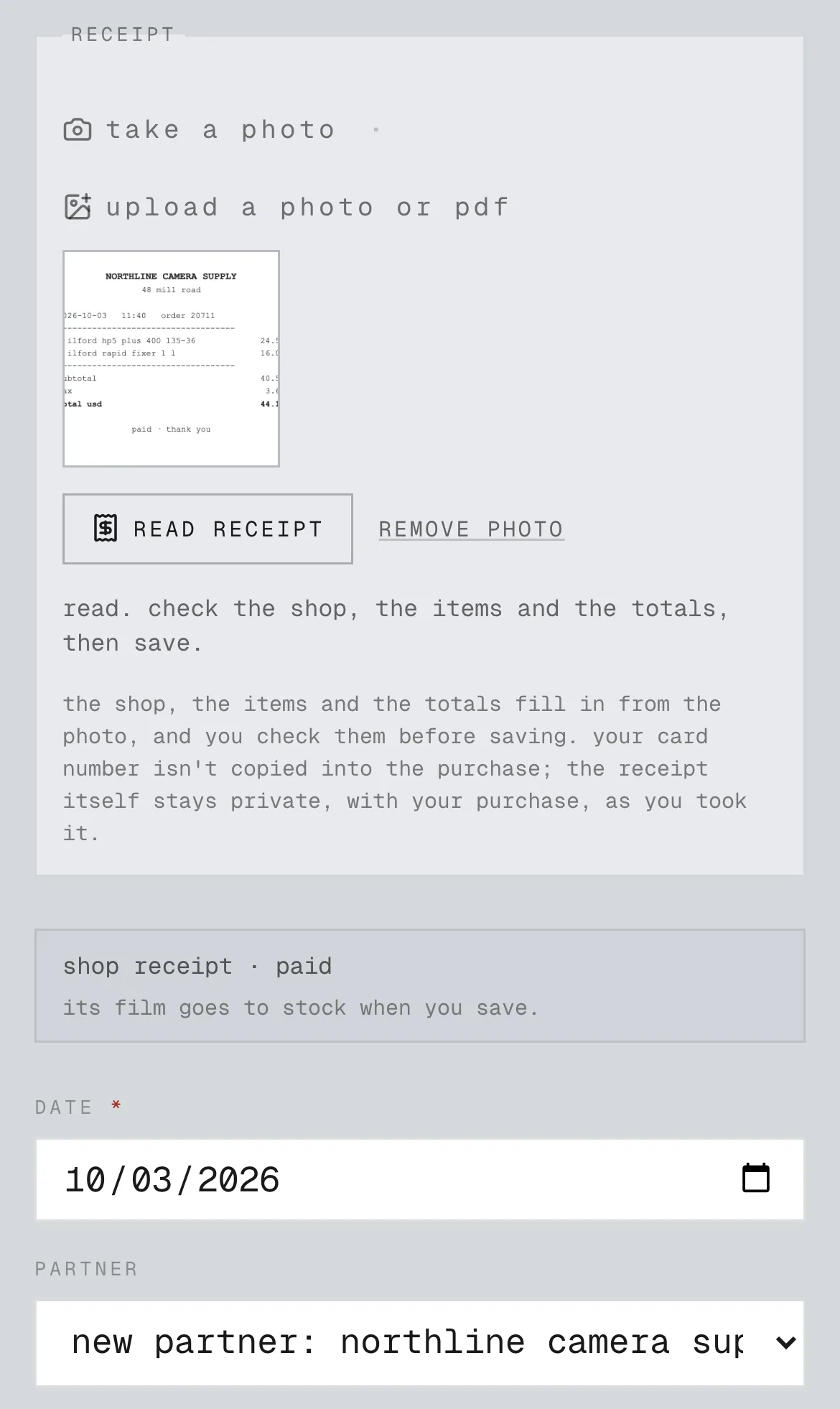 an example from a fictional practice. lab's purchase form with a camera shop's receipt photo, read, and the shop and date filled in to check before saving.